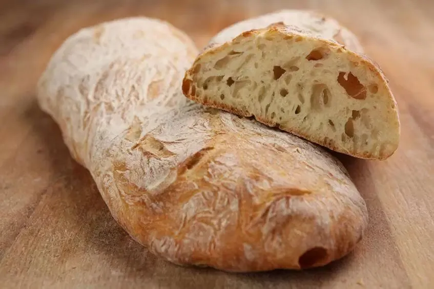 Baking bread in a wood burning oven: at what temperature and for how long?